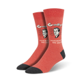 Pair of crew socks in coral red with a dark grey cuff.  The socks feature a retro-style illustration of a man's face and the text 'Golly, You Really Do Suck'.