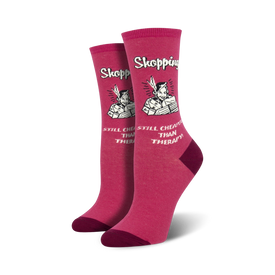 pink crew socks with white text "shopping...still cheaper than therapy" cartoon of a lady with shopping bags  