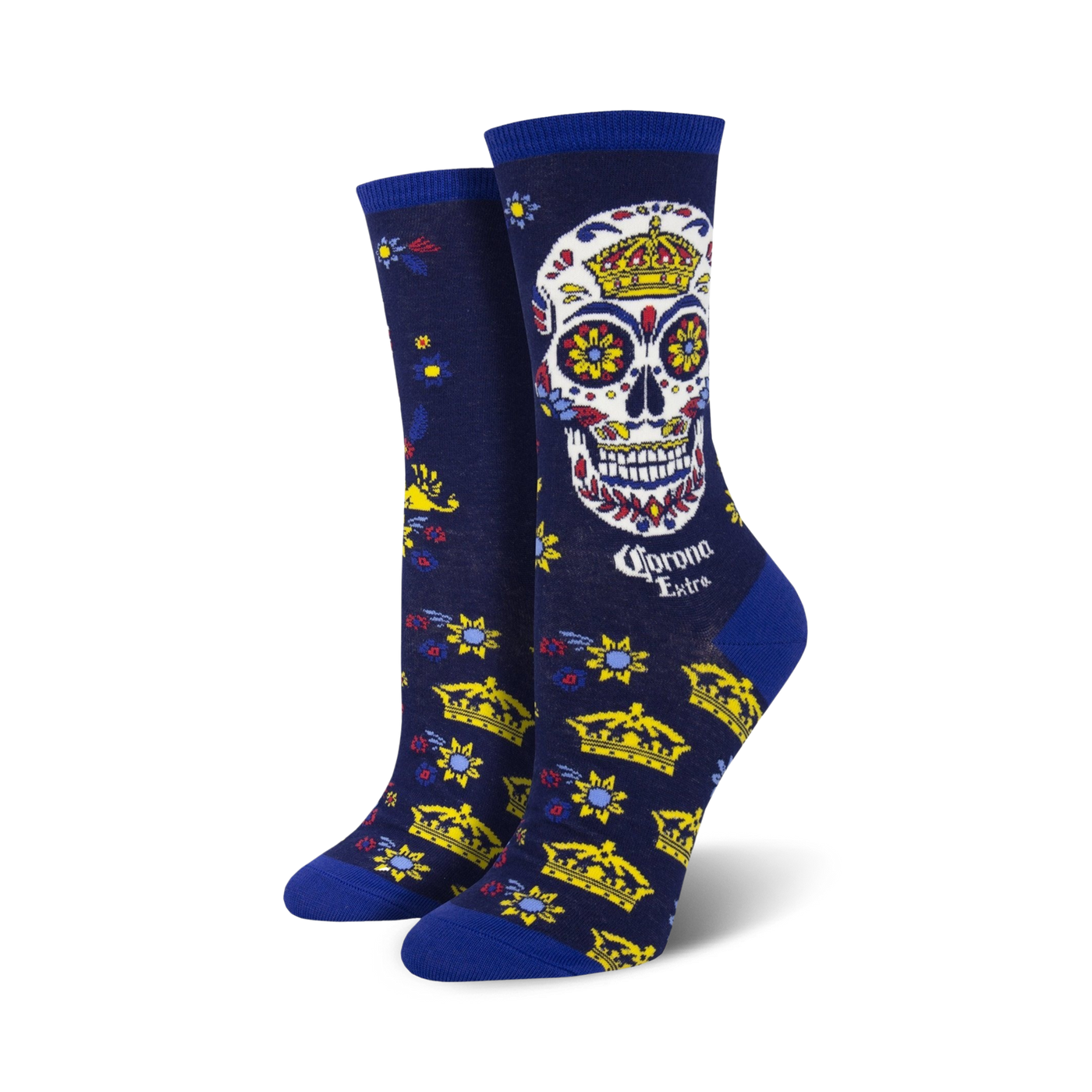 Women's crew socks in navy blue, featuring a colorful sugar skull with a crown, gold crowns, and floral details. Corona Extra logo is visible.