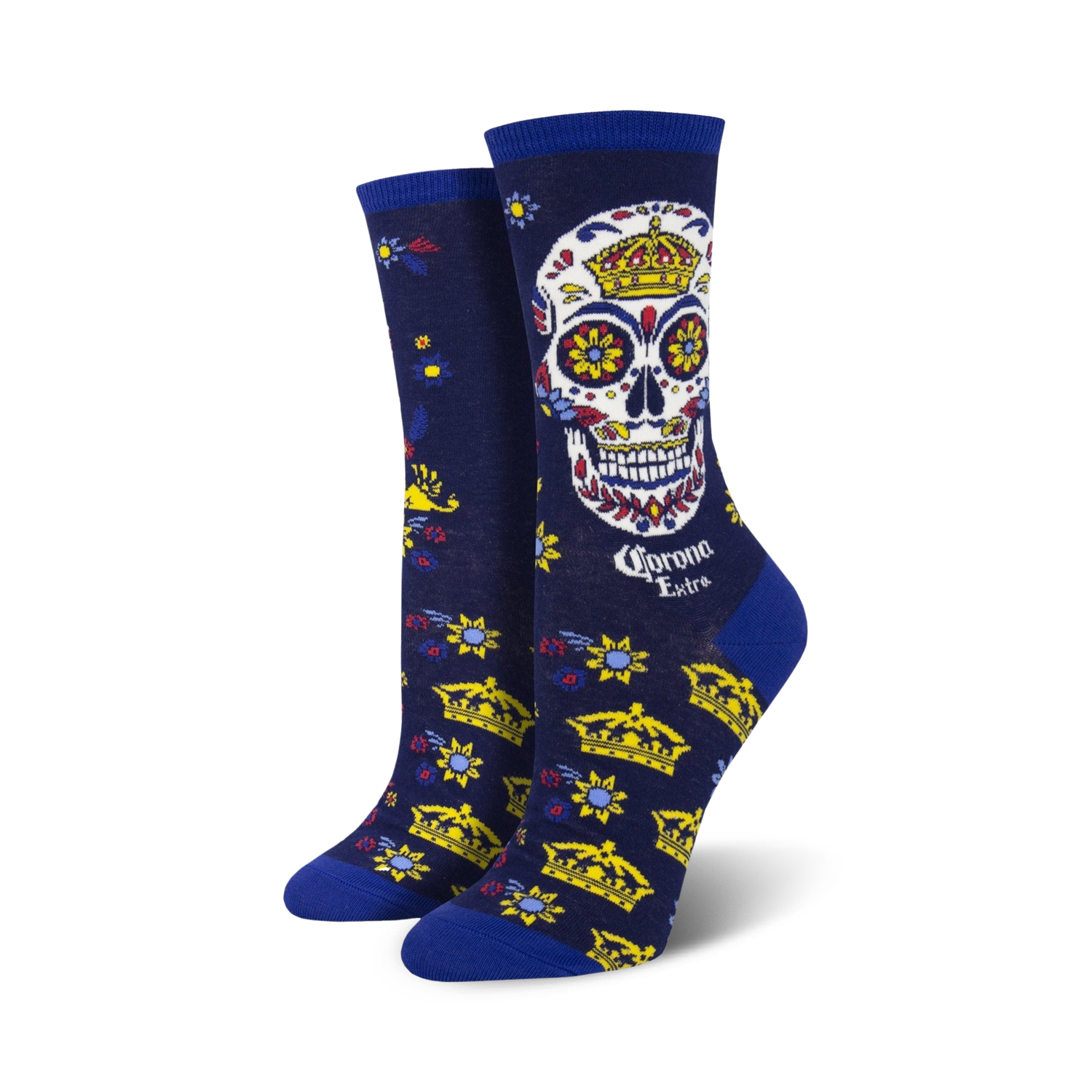Women's crew socks in navy blue, featuring a colorful sugar skull with a crown, gold crowns, and floral details. Corona Extra logo is visible.