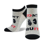 Close-up of gray and black 'Don't Quit, Do It' ankle socks with barbell design.