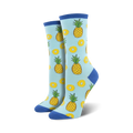 Lifestyle shot showing the light blue 'Partial To Pineapples' socks on a model's feet. The socks' fun design is highlighted.