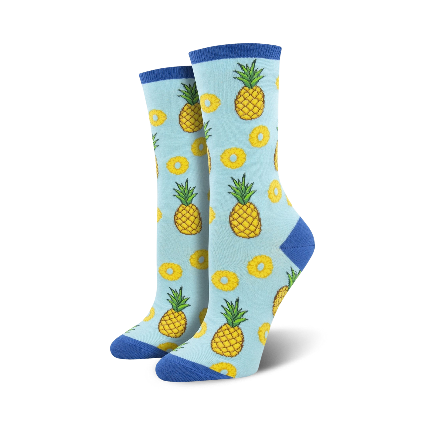 Lifestyle shot showing the light blue 'Partial To Pineapples' socks on a model's feet. The socks' fun design is highlighted.