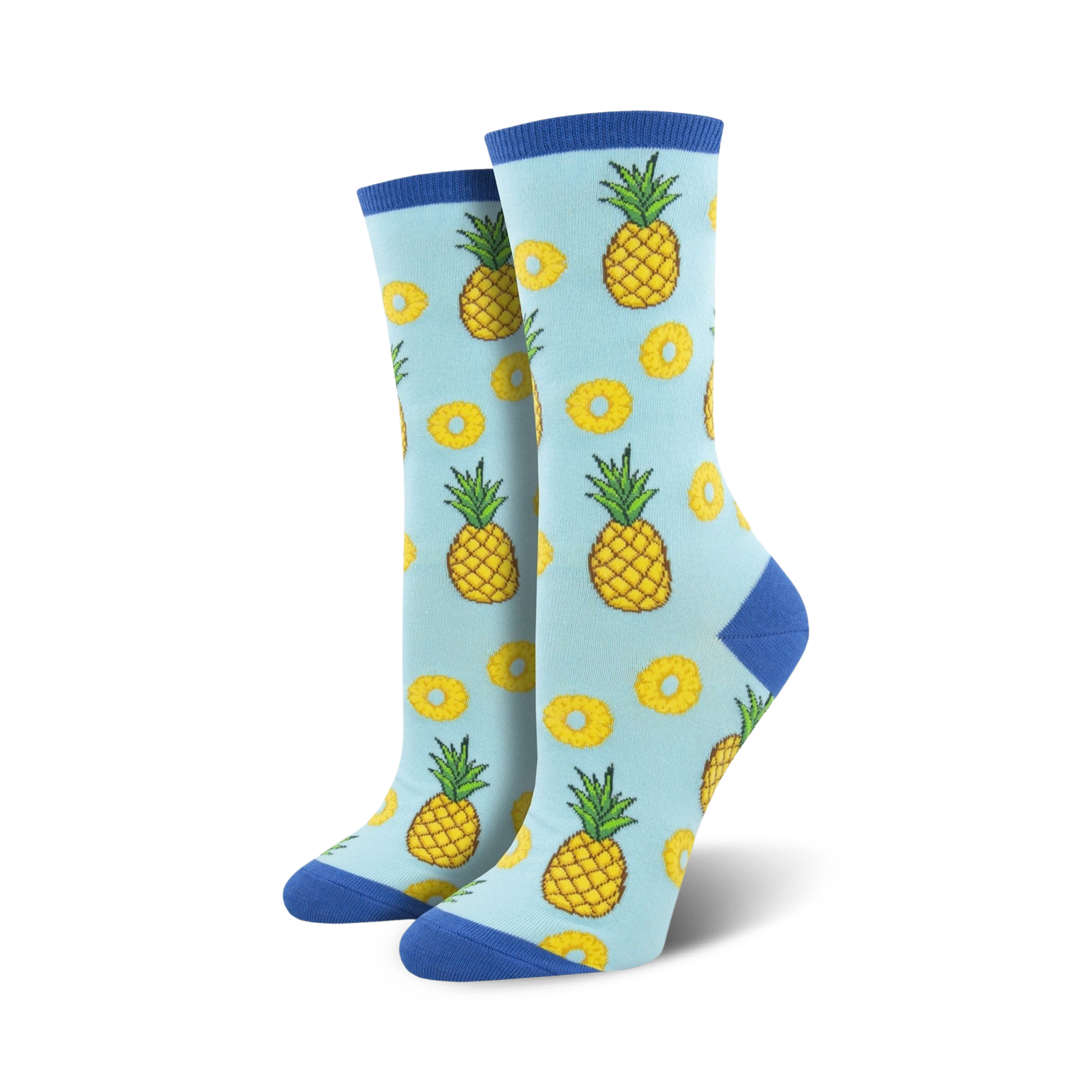 Lifestyle shot showing the light blue 'Partial To Pineapples' socks on a model's feet. The socks' fun design is highlighted.