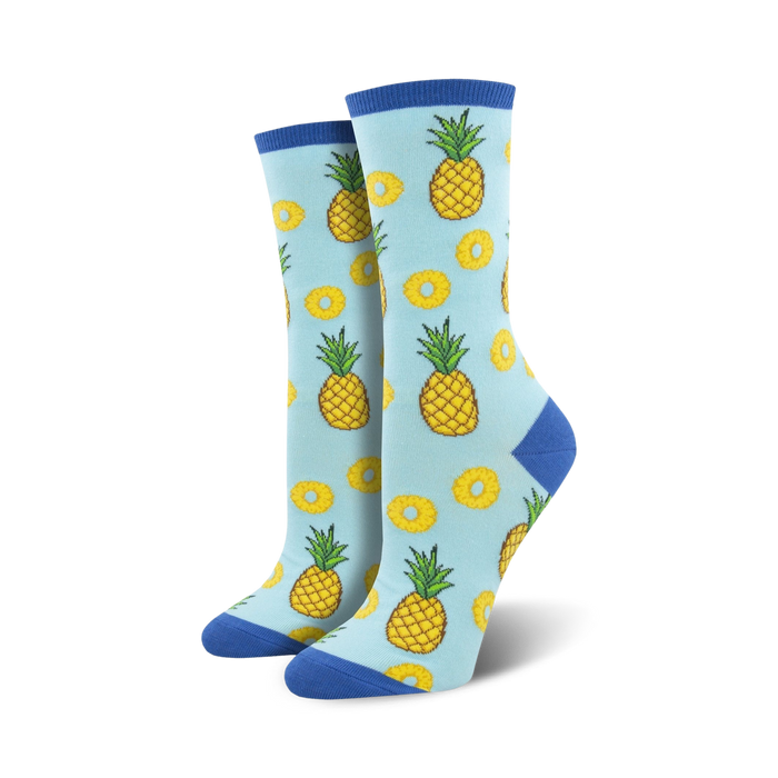 crew length women's socks with a pineapple print in yellow with green leaves and white slices with yellow edges.  