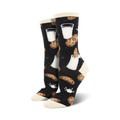 Lifestyle shot of a person wearing the black 'Mmm Cookies' socks; black socks with cookie and milk design.