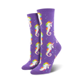 Pair of women's crew socks. Purple background with repeating pattern of rainbow-maned seahorse unicorns and small bubbles.