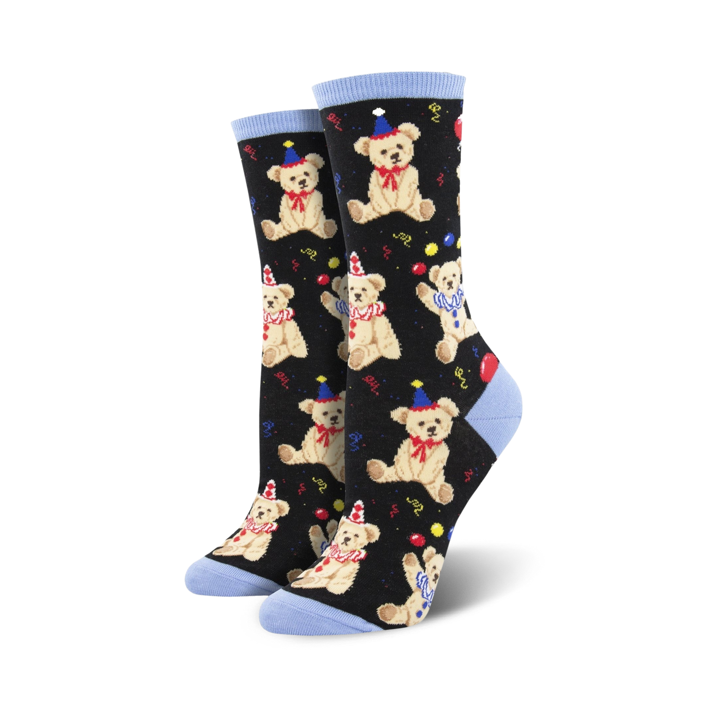 A pair of black crew socks with a pattern of light brown teddy bears wearing party hats.  Red and yellow balloons and confetti are scattered amongst the bears. The socks have light blue cuffs.