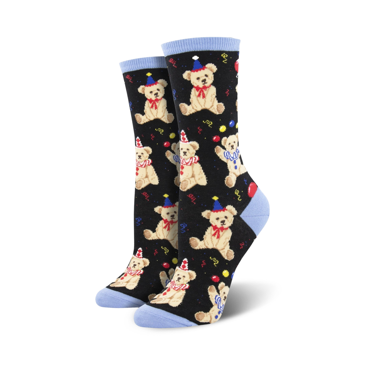 A pair of black crew socks with a pattern of light brown teddy bears wearing party hats.  Red and yellow balloons and confetti are scattered amongst the bears. The socks have light blue cuffs.