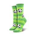 Pair of women's crew socks with a soccer field design. The socks are lime green with white stripes and black-and-white soccer balls.