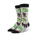 Pair of crew socks in grey and black, featuring a fun print of various cryptids including Bigfoot, Nessie, and aliens.