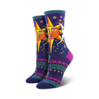 Pair of women's crew socks. Deep purple background with a whimsical sun and moon design. Colorful Southwestern-inspired pattern at the bottom.