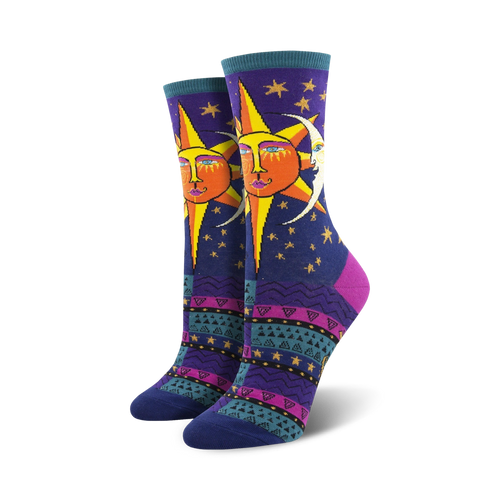 Pair of women's crew socks. Deep purple background with a whimsical sun and moon design. Colorful Southwestern-inspired pattern at the bottom.