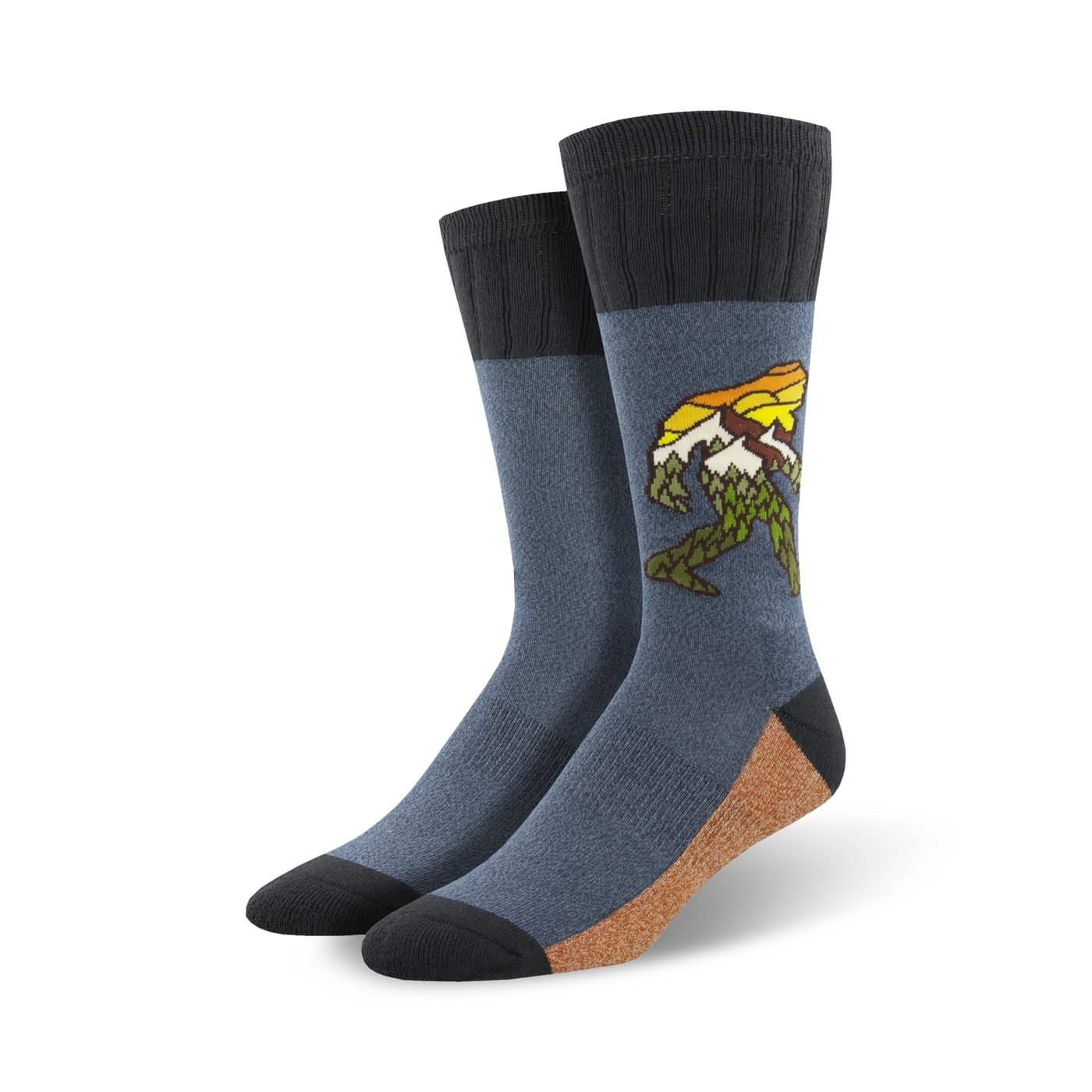 A pair of men's crew socks in blue and tan, featuring a graphic of Bigfoot walking through a mountain range.  The design includes yellow and green accents.