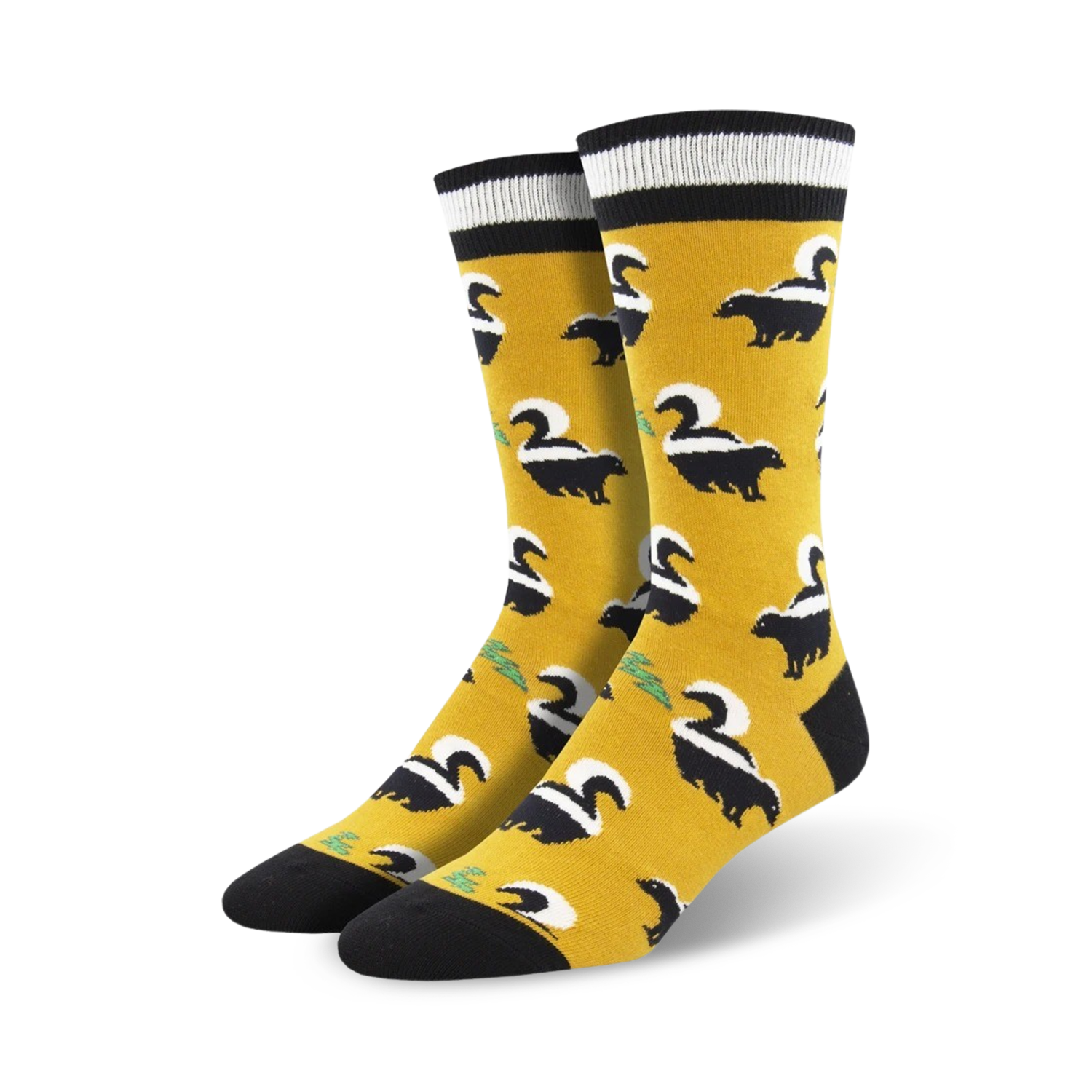 Pair of mustard yellow crew socks with a black skunk pattern.  Features black and white stripes at the top.