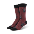 Burgundy crew socks with a repeating pattern of black stag beetles.  A stylish and fun design for adding a unique touch to any outfit.