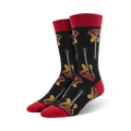 A pair of men's crew socks in black with red cuffs. The socks feature a repeated pattern of yellow and red electric guitars.