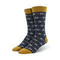 Pair of men's crew socks.  Navy blue with grey barbed wire pattern and mustard yellow cuff.