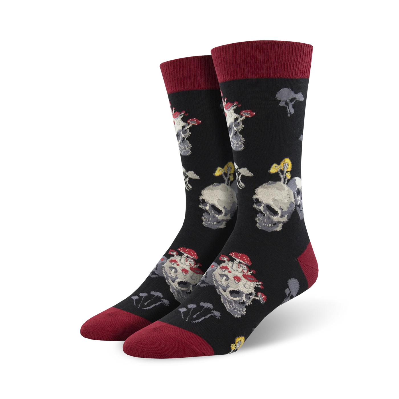 Pair of black crew socks with a fun design. Skulls are topped with red and white mushrooms. The socks have burgundy cuffs.