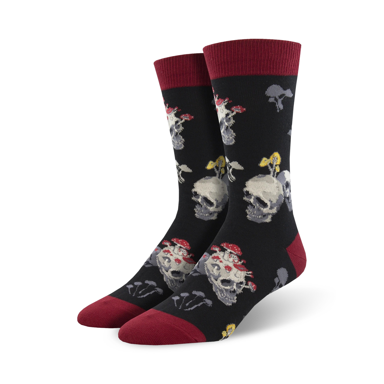 Pair of black crew socks with a fun design. Skulls are topped with red and white mushrooms. The socks have burgundy cuffs.