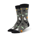 Pair of crew socks, gray with black accents. Feature Halloween designs: ghosts, spiders, bats, candy corn, and eyeballs.