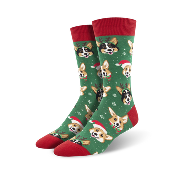 mens green crew socks with cartoon corgis wearing santa hats and reindeer antlers surrounded by snowflakes. holiday/christmas theme.   