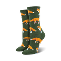 Lifestyle shot of Socksy Foxes socks on a woman's feet, showing the socks in the green colorway.