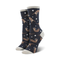 Lifestyle shot showing the 'Otter Space' socks on a model's feet. The socks are dark grey with brown otters in space helmets against a background of stars.