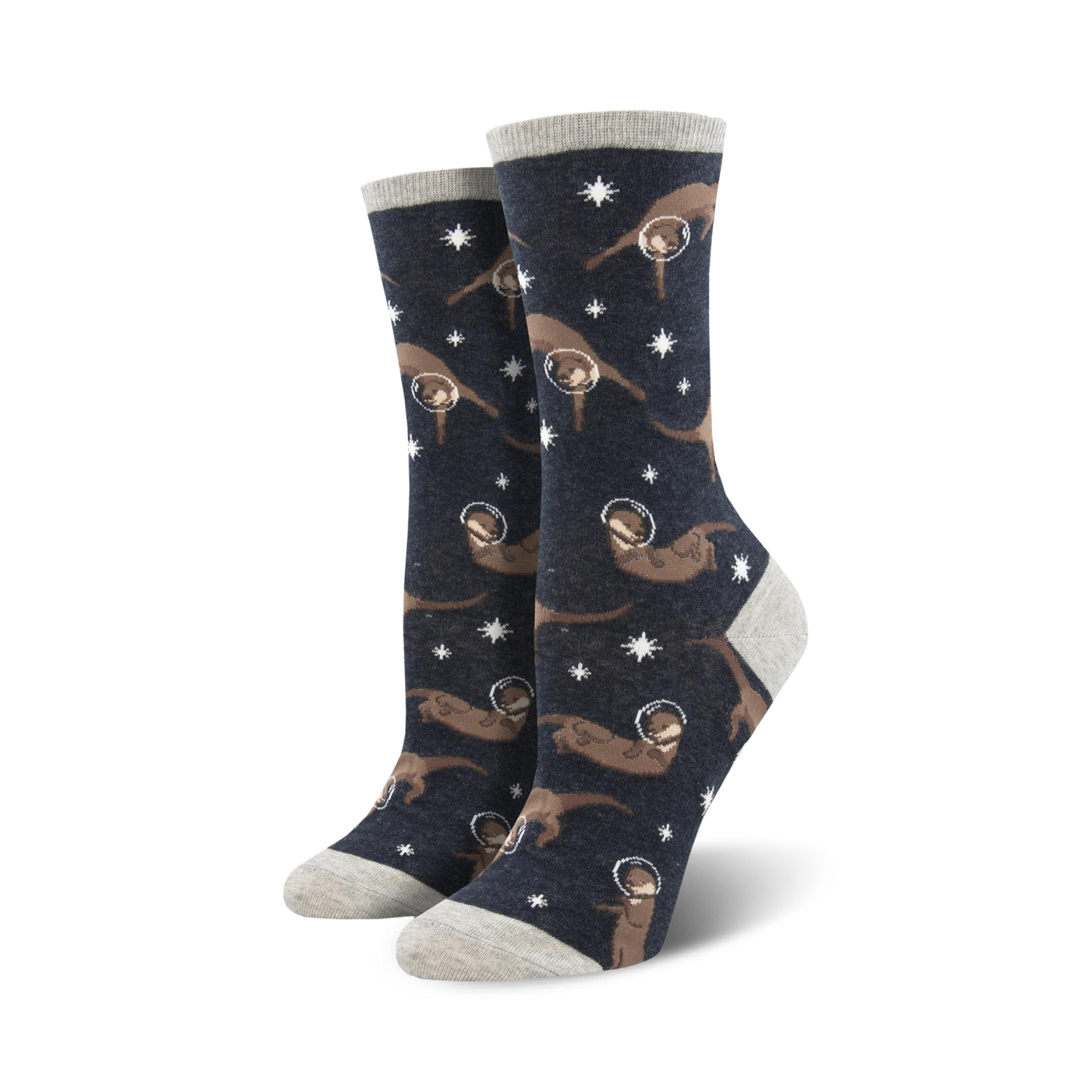 Lifestyle shot showing the 'Otter Space' socks on a model's feet. The socks are dark grey with brown otters in space helmets against a background of stars.