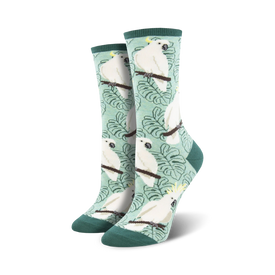 white cockatoo crew socks flaunt yellow crests, light orange cheeks, and green leaves on a pale green backdrop. perfect for women seeking unique and colorful animal-themed hosiery.  