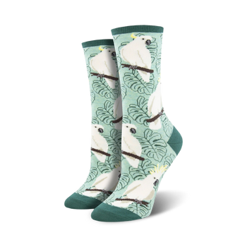 white cockatoo crew socks flaunt yellow crests, light orange cheeks, and green leaves on a pale green backdrop. perfect for women seeking unique and colorful animal-themed hosiery.  