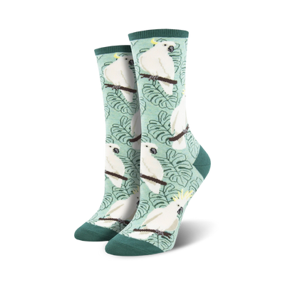 white cockatoo crew socks flaunt yellow crests, light orange cheeks, and green leaves on a pale green backdrop. perfect for women seeking unique and colorful animal-themed hosiery.  