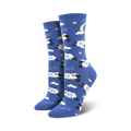 Pair of crew socks in blue with white clouds, stars, a crescent moon, and black sheep jumping.  The sheep have 'Zzz' above them.