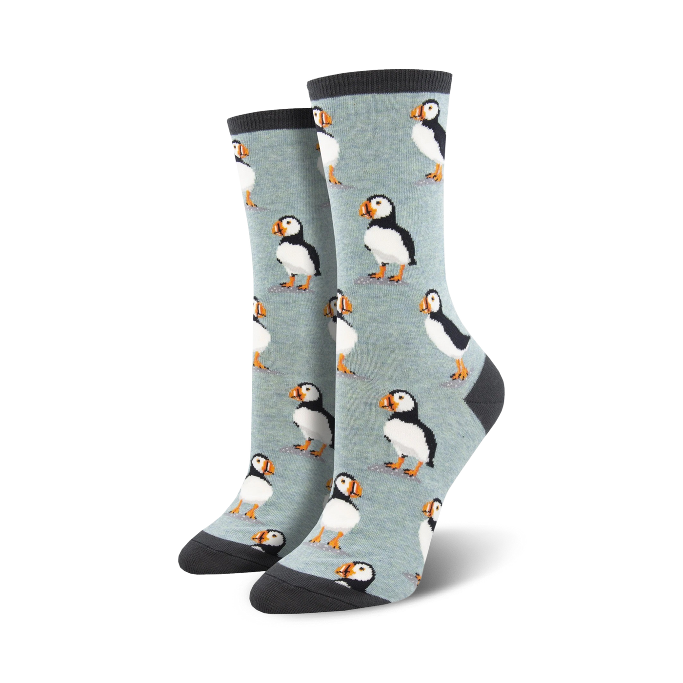A pair of women's crew socks in light blue with a repeating pattern of illustrated puffins. The socks have dark gray cuffs.