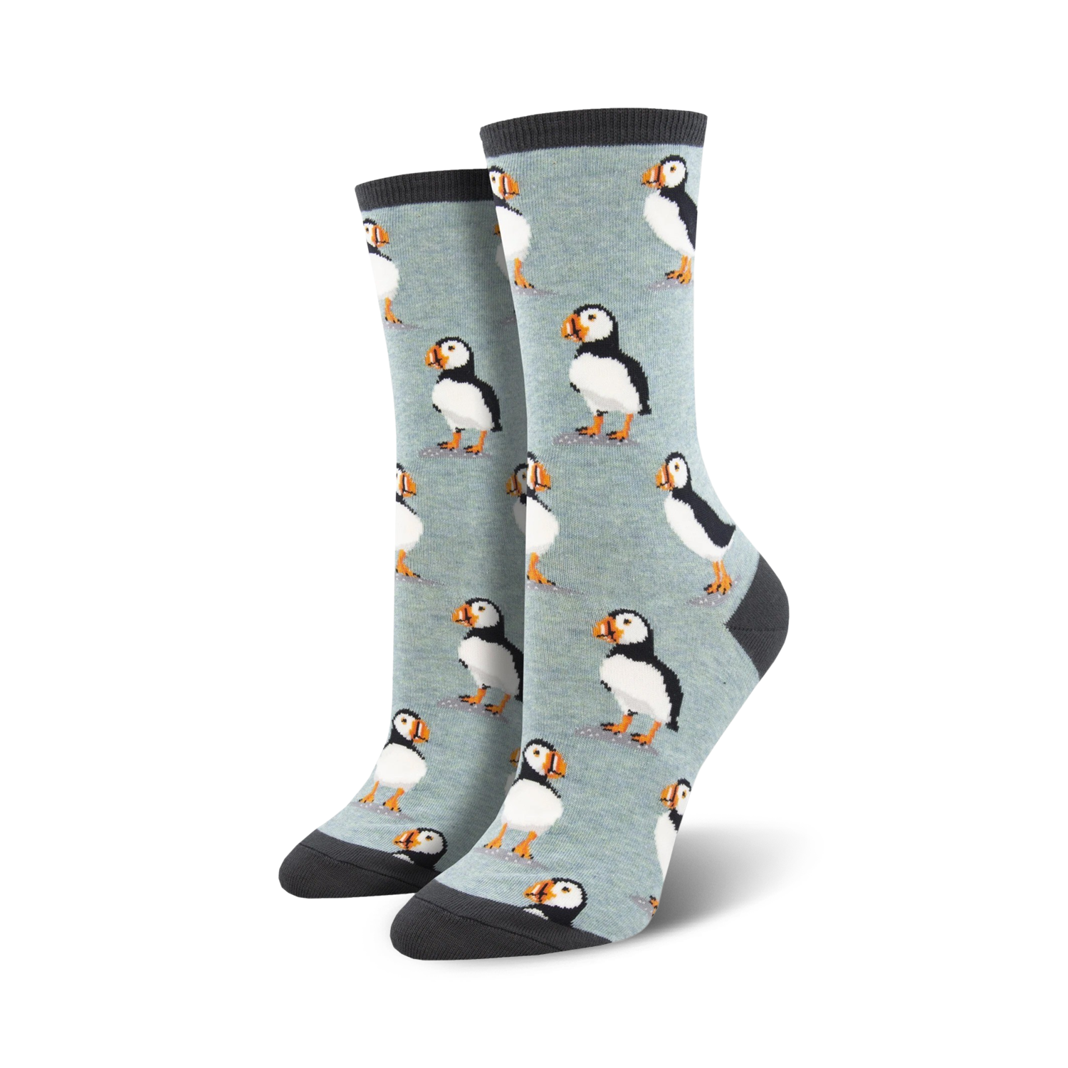 A pair of women's crew socks in light blue with a repeating pattern of illustrated puffins. The socks have dark gray cuffs.