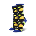 A pair of crew socks with a fun design. The black socks are adorned with colorful tacos and lime margaritas. The socks have a royal blue cuff.