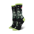 A pair of black crew socks with a green haunted house, ghosts wearing Santa hats, and snowflakes. Lime green cuffs.
