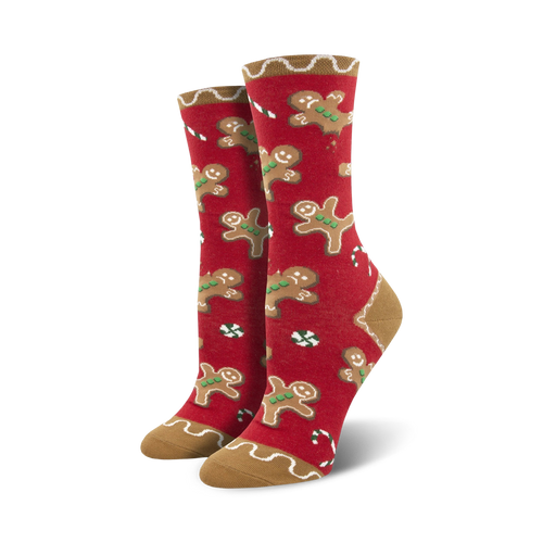 Lifestyle shot showing the red version of the Goodie Gumdrop socks, with the same gingerbread men and candy cane design.