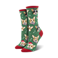 Pair of crew socks; green background with festive Corgis wearing Santa hats and reindeer antlers; snowflakes for a holiday feel.