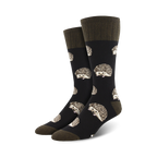 Pair of crew socks with a dark background and a repeating pattern of cute hedgehogs.  The socks are primarily dark grey/black with beige hedgehog details and olive green cuffs.
