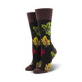 Pair of women's crew socks with autumn leaf design.  Dark background with multicolored leaves in red, yellow, and green.  Brown cuff.