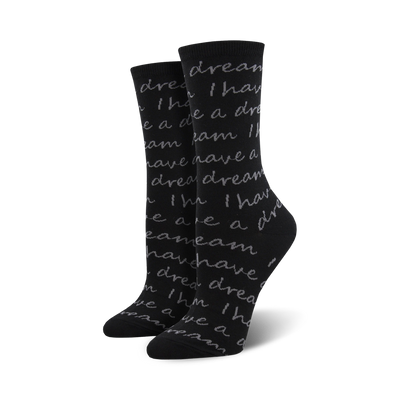 women's crew socks in black with a pattern of light grey text repeating "i have a dream" in handwritten font, celebrating martin luther king. 