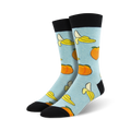 Pair of light blue crew socks with a whimsical pattern of yellow bananas and orange peaches.