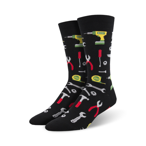Pair of black crew socks with a fun pattern of colorful tools like hammers, wrenches, pliers, and drills.