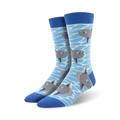 A pair of crew socks with a light blue background and illustrated gray ocean sunfish swimming. The socks have a royal blue cuff.