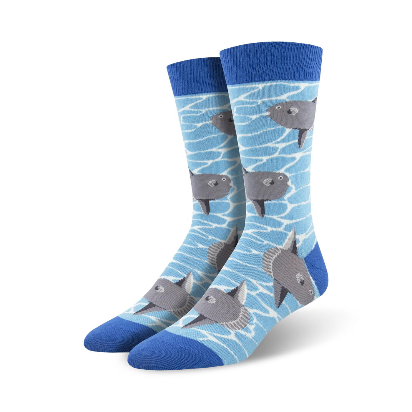 A pair of crew socks with a light blue background and illustrated gray ocean sunfish swimming. The socks have a royal blue cuff.