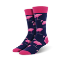 A pair of men's crew socks in navy blue, adorned with a repeating pattern of pink flamingos. The socks have a pink cuff.