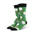 Pair of men's green crew socks with golf ball and tee design. White golf balls and red, blue, and white tees are on a green background.