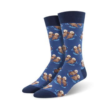 dark blue crew length socks with cute cartoon otters swimming and holding hands on a blue-green water wavy background. wonderful for men.   