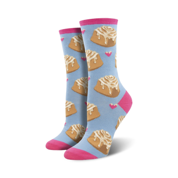 Pair of women's crew socks with a pastel blue background featuring a pattern of cinnamon rolls and pink hearts. Pink cuffs.